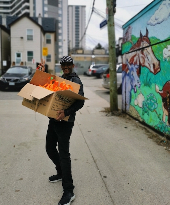 Volunteer carrying a box full of supplies